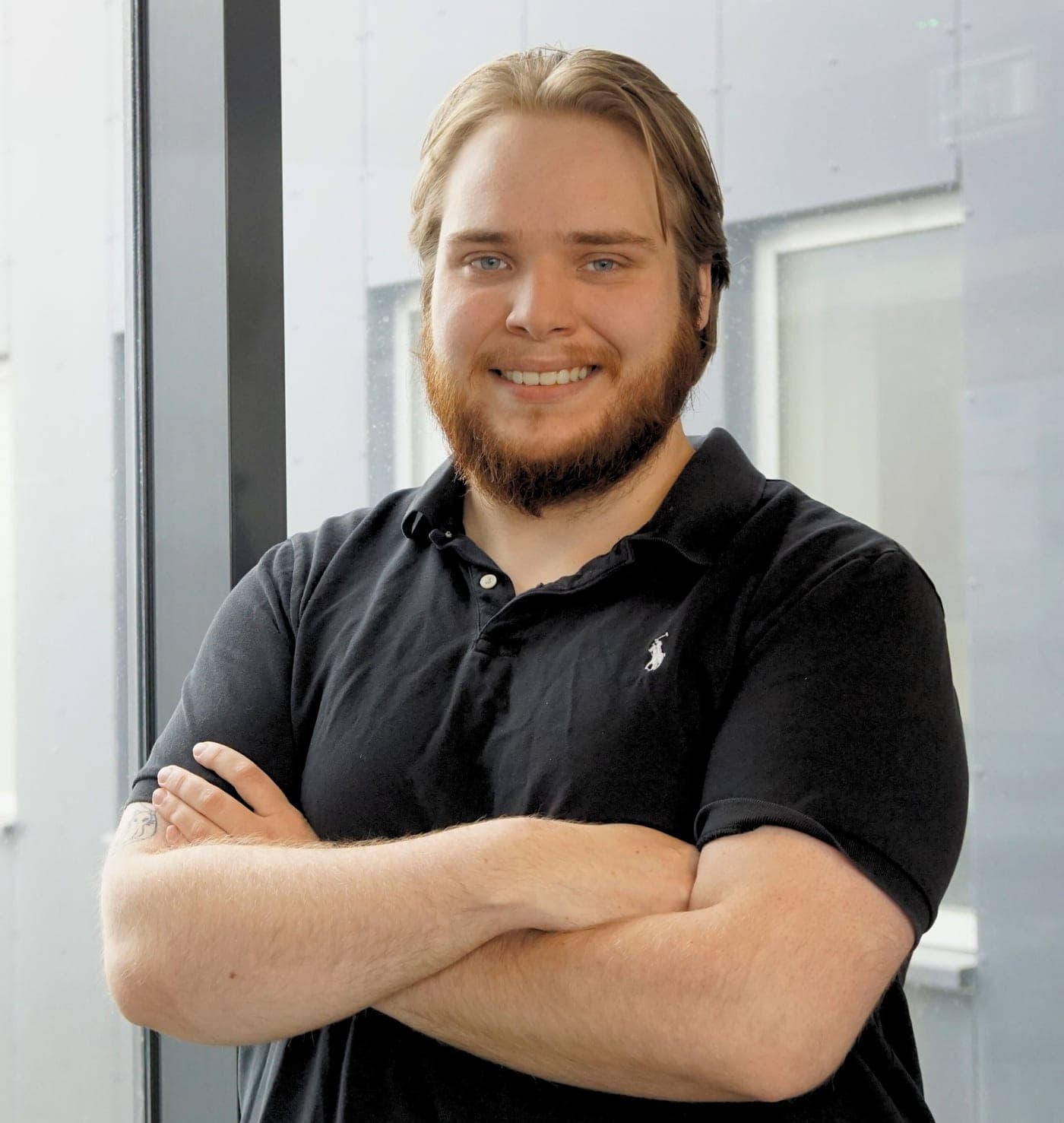 Andri Pétur Hafþórsson, arms crossed, black polo